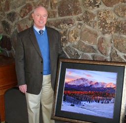 Dr. David M. Phillips with a mural of Pikes Peak